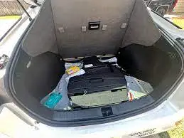 whelbarrow fit in a car
the trunk of a car with luggage