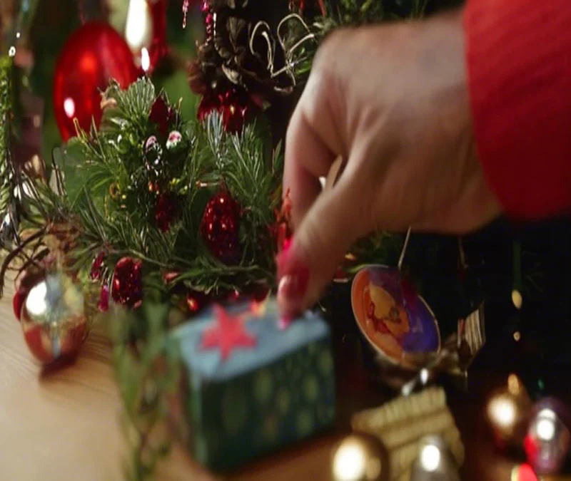 a person's hand touching a small box with ornaments
Wheelbarrow For Christmas
a wheelbarrow full of christmas lights